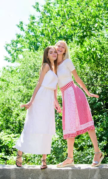 Friendship concept. Girls friends summer dress outfit nature background. Friendly relations. Summer rest. Summer vacation and relax. Revelation and sincerity. Carefree youth friends hang out outdoors