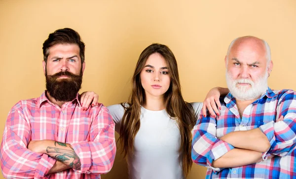 checkered male and female fashion. family values. generation and gender concept. relationship. hairdresser and barber shop salon. fashion style. serious emotions. young lady with two bearded men