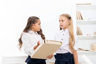 Needing homework help. Adorable small children holding file with homework in classroom. Doing homework assignment. Too much homework is bad for kids clipart