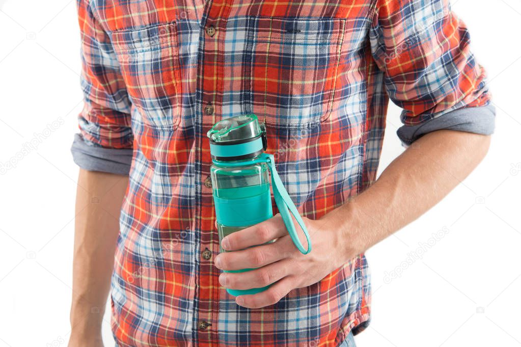 Refillable bottle. Hand hold water bottle or sport drink white background. Bottle in muscular male hand. Sport and water balance concept. Sportive drink in bottle. Eco and zero waste lifestyle