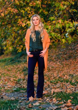 Hafta sonu için rahat kıyafet fikirleri. Kız sevimli sarışın sıcak ve rahat kıyafeti sonbahar doğa arka plan defocused poz. Kadın gün batımı saatinde yürüyor. Geç sonbahar için rahat rahat kıyafetler. Rahat ve rahat