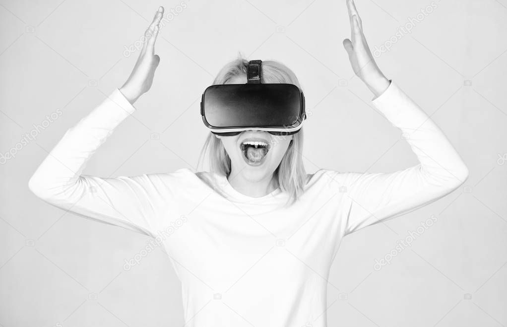 Excited smiling businesswoman wearing virtual reality glasses. Woman watching virtual reality vision. A person in virtual glasses flies in room space. VR headset.