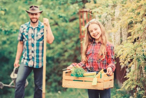 Working with plants is great pleasure. ecology. Gardening tools. little girl and happy man dad. earth day. family farm. father and daughter on ranch. spring village country. Gardening is my passion