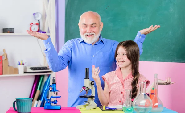 Lección escolar. Buena clase de pedagogo amistoso. Expande tu mente. Química y biología. El profesor ayuda a la colegiala. Niña con tutor de hombre estudiar ciencias. Carrera de pedagogo. Pedagogo experimentado — Foto de Stock