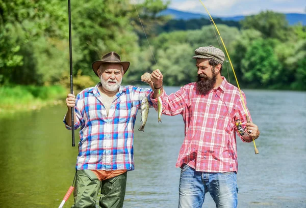Mature man with friend fishing. Summer vacation. Fisherman with fishing rod. Activity and hobby. Fishing freshwater lake pond river. It is not sport, it is obsession. Bearded men catching fish — Stock Photo, Image