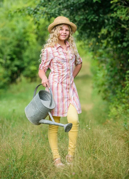 Watering plants in garden. Spring gardening checklist. Improve irrigation timing. Optimize water use. Measure soil water content temperature and salinity. Watering tools. Girl child hold watering can — Stock Photo, Image