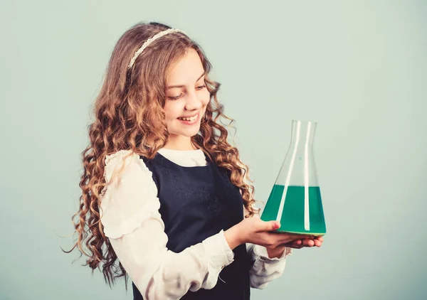 Education concept. School chemistry lesson. Chemical analysis. Harmful and vital options of chemical solute. Girl school pupil study chemical liquids. School laboratory. Learn patterns of nature