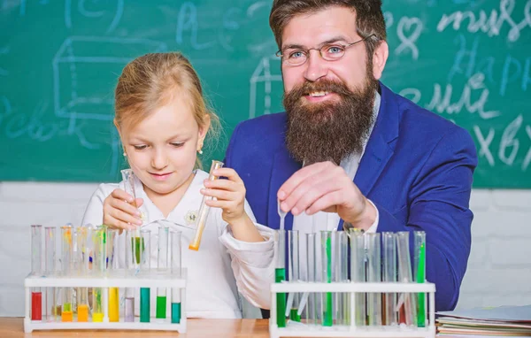 Explaining chemistry to kid. How to interest children study. Fascinating chemistry lesson. Man bearded teacher and pupil with test tubes in classroom. Private lesson. School chemistry experiment — Stock Photo, Image