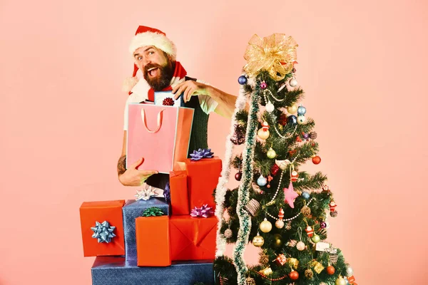 Black Friday sale. Guy in red hat with shopping bags