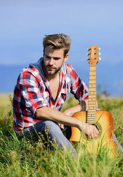Pleasant time alone. Peaceful mood. Guy with guitar contemplate nature. Inspiring nature. Musician looking for inspiration. Dreamy wanderer. Wanderlust concept. Summer vacation highlands nature — Stock Photo, Image