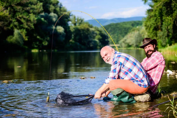 Illegal hunting caviar. Extracts eggs from sturgeon caught river. Trap for fish. Men sit at riverside with fishing equipment. Poaching crime and fishing license. Poachers fishing. Black market caviar — Stock Photo, Image