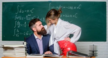 Distracting him from work. Private lesson. Check knowledge. Teacher and student in classroom chalkboard background. Sexy seduction. Desire for knowledge. Sex knowledge. Need for real experience clipart