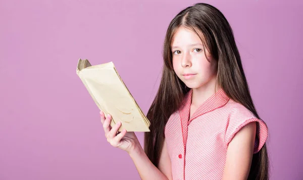 Fiction et non-fiction. Joli livre de lecture pour petit enfant sur fond violet. Soif de connaissance. Adorable ver de bibliothèque. Lire la littérature comme passe-temps. Petite fille apprend à lire. Concept d'enseignement à domicile — Photo