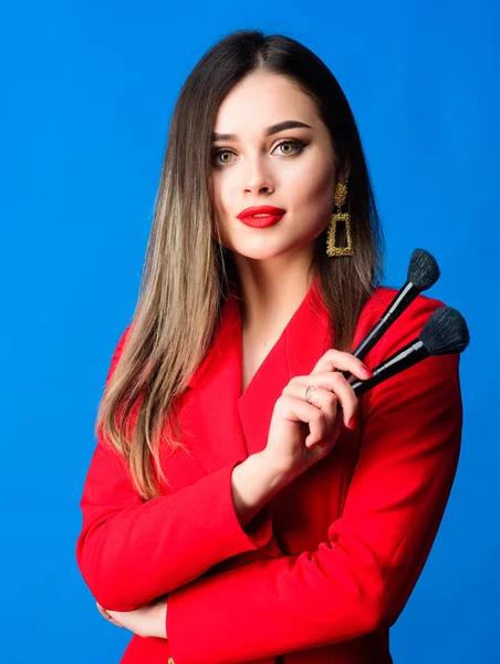 Strengthen confidence with bright makeup. Perfect skin tone. Makeup artist concept. Looking good and feeling confident. Gorgeous lady makeup red lips. Attractive woman applying makeup brush