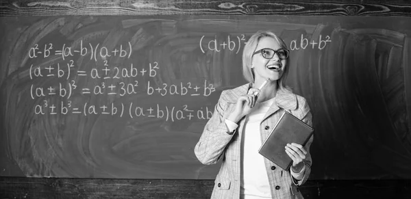 Teacher smart woman with book explain topic near chalkboard. What makes great teacher. School teacher explain things well and make subject interesting. Teaching complex multifaceted activity — Stock Photo, Image