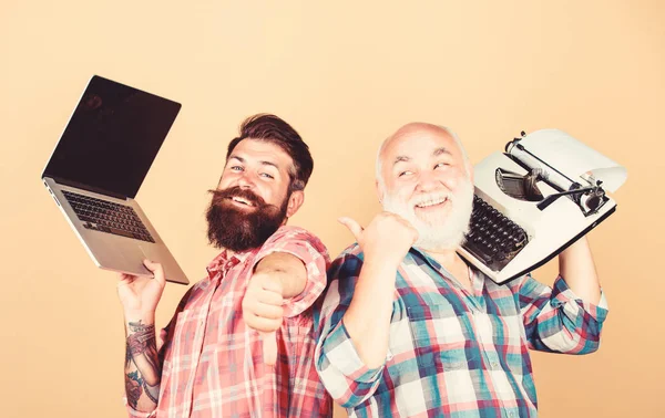 Men work writing devices. Digital technologies. Battle of technologies. Old generation. Modern life and remnants of past. Senior man with typewriter and hipster with laptop. Master new technologies — Stock Photo, Image