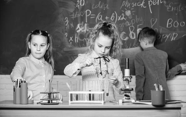 Explore biological molecules. Future technology and science concept. Children study biology or chemistry school. School education. School girls study. Kids in classroom with microscope and test tubes