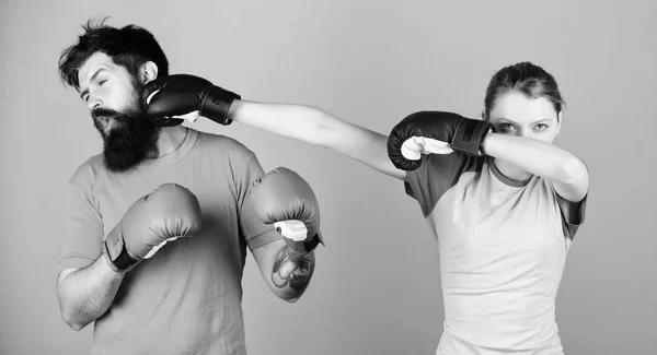 Amateur boxing club. Strength and power. Family violence. Man and woman in boxing gloves. Boxing sport concept. Couple girl and hipster practicing boxing. Sport for everyone. Equal possibilities