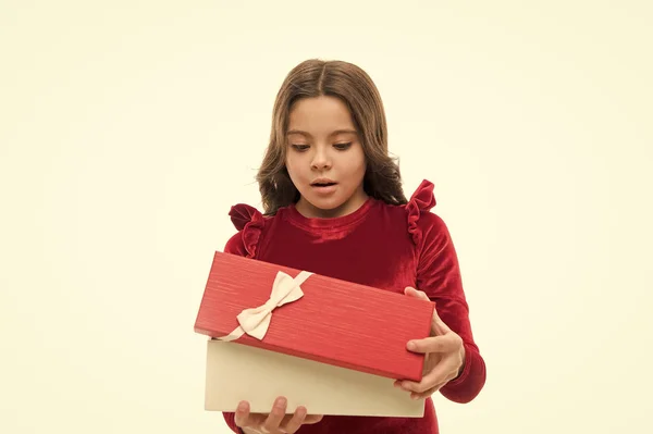 Una niña emocionada por desempacar su regalo. Pequeña linda chica recibió regalo de vacaciones. Lo que hay dentro. Los mejores juguetes y regalos de Navidad para niños. Niño niña en elegante vestido rizado peinado celebrar caja de regalo —  Fotos de Stock