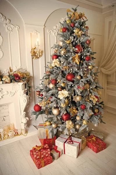 Merry Christmas and Happy Holidays. Christmas. Beautiful decorated tree with present box. Happy new year. The morning before Xmas. New year holiday. Christmas composition. fire place. This is for you