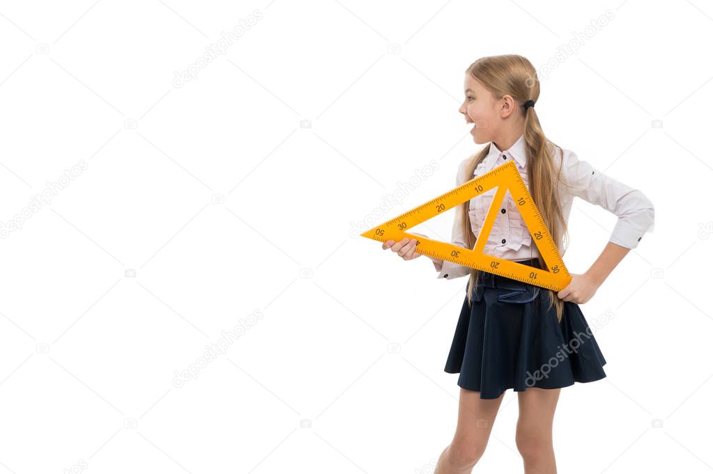 School concept. Small child with measuring instrument school lesson. Little girl preparing for geometry lesson. Cute schoolgirl holding triangular ruler for lesson. Having fun. Appreciate knowledge