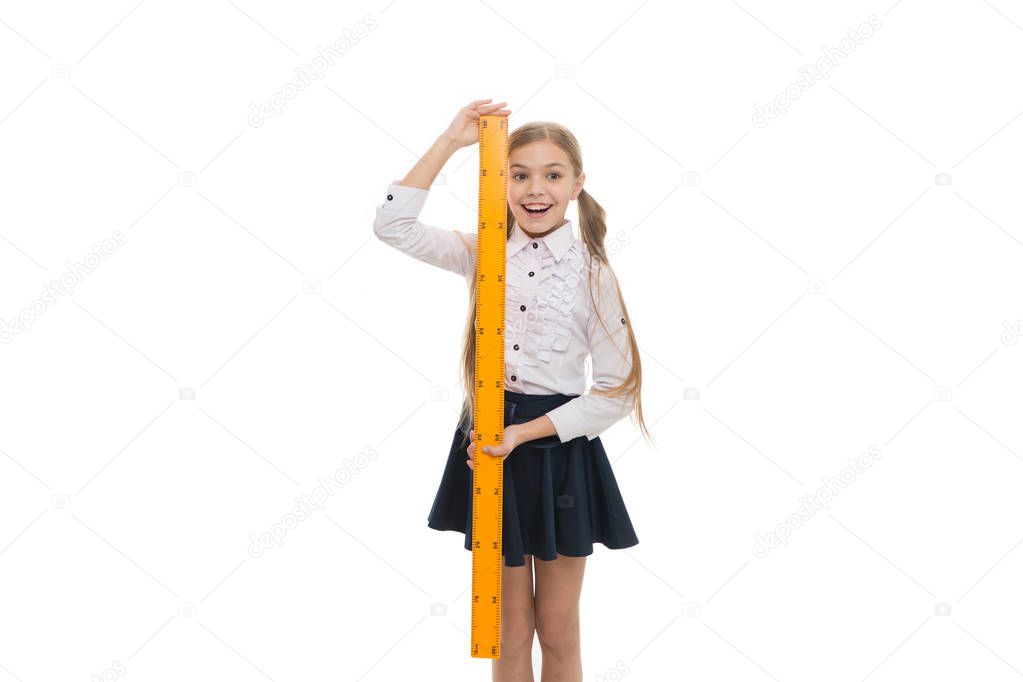 STEM concept. Draw geometric figures. Pupil cute girl with big ruler. Favorite school subject. Education and school concept. School student learning geometry. Kid school uniform isolated white