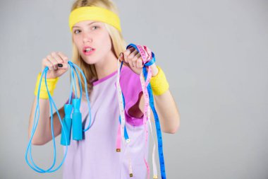 Egzersiz sonucu. Kız ip atlama tutun ve bant ölçmek. İnce aşağı. Egzersiz sporve diyet. Hazır yaz vücut alın. Kilo kaybı kavramı. Egzersiz için zaman bulun. İp atlama ile kadın egzersiz