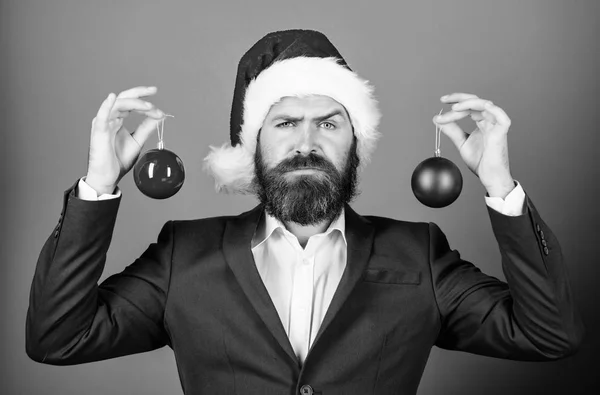 Christmas atmosphere spread around. Holidays meant for fun. Man bearded wear formal suit and santa hat. Businessman join christmas celebration. Santa hold christmas ball decoration. Merry christmas