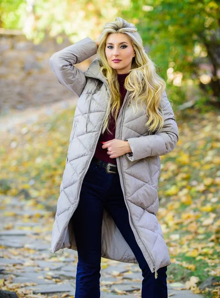 How to rock puffer jacket like star. Puffer fashion trend concept. Girl fashionable blonde walk in autumn park. Woman wear warm grey jacket. Jacket everyone should have. Oversized jacket trend