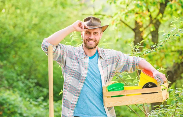 happy earth day. Eco living. farming and agriculture cultivation. Garden equipment. muscular ranch man in cowboy hat. sexy farmer hold shovel and box with pot. Eco farm worker. Harvest. I love flower