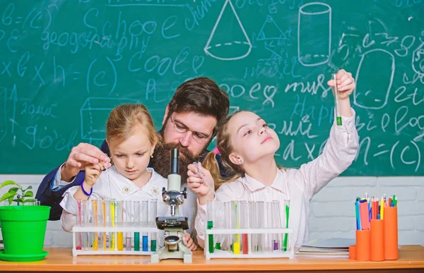 Prove it. Little girls performing experiment under teacher supervision. Small school children holding test tubes for laboratory experiment. Demonstration and experiment — Stock Photo, Image