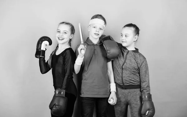 Fitness energy health. punching knockout. Team sport success. workout of small girls boxer and boy in sportswear. Happy children in boxing gloves with tennis racket and ball. boxing