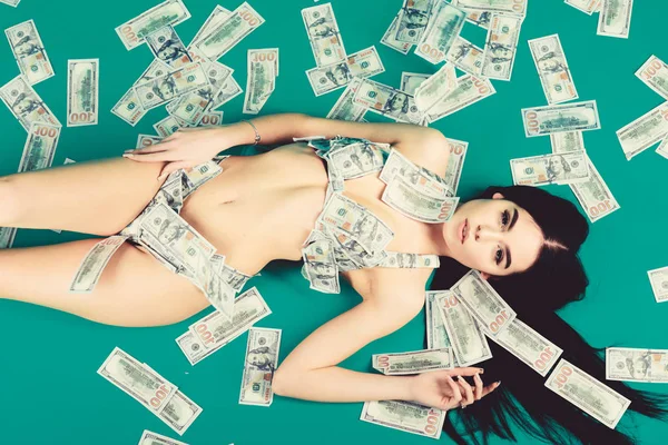 Richness and wellbeing. Girl sexy breasts long hair relaxing cash money background. Sexy girl wear bikini dollar banknotes. Luxury girlfriend. Rich woman sexy body. Luxury resort. Enjoying her profit