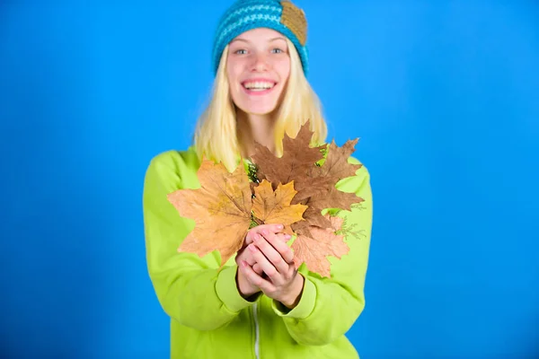 Enjoy autumn season. Autumn skincare tips. Bright moment. Active leisure and rest autumn season. Woman wear knitted hat hold fallen leaves. Skincare and beauty tips. Skincare routine for autumn — Stock Photo, Image