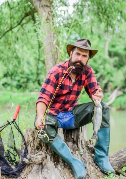 Lucky day. Fishing is always better on other side of lake. Man satisfied caught fish. Fishing outdoor sport. Fishing hobby. Fisherman and trophy trout fish. Good things come to those who bait