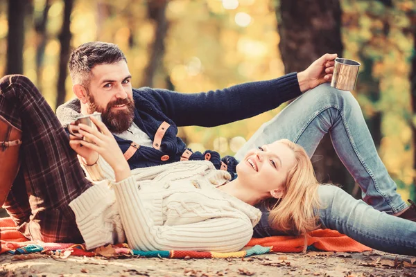 Romantic picnic forest. Couple in love tourists relaxing on picnic blanket. Vacation weekend picnic camping and hiking. Tourism concept. Picnic time. Happy loving couple relaxing in park together