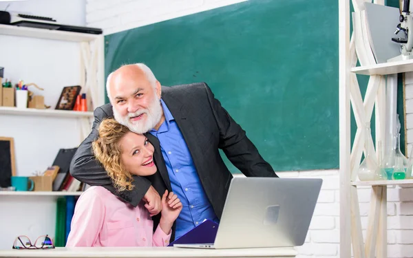 Cool moments. pass exam. teachers room. senior teacher and woman at school lesson. student and tutor with laptop. modern school education. happy student girl with tutor man at blackboard