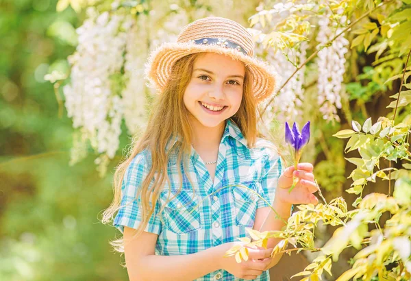 Kid hold flowers bouquet. Girl cute adorable teen dressed country rustic style checkered shirt nature background. Summer garden flower. Fresh flowers. Collecting flowers in field. Summer is here