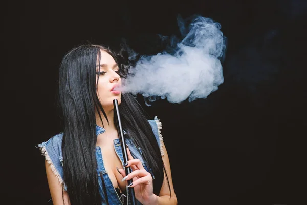 hookah bar. Electronic cigarette. sexy woman smoking cigar. exhale smoke on black background. Bad habit. Woman vapor. unhealthy addiction. Tabacco drug. copy space. be drug free