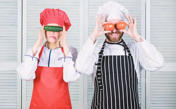 Couple play with ingredients for vegan dish. Cooking vegan meal. Cooking together is fun. Menu for our family. Go vegan. Organic nutrition. Vegan family. Man and woman chef hold vegetables having fun