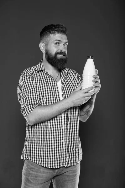 Health care and diet. Milk products. Consuming lactose. Healthy nutrition. Yogurt probiotics and prebiotics. Bearded man hold white bottle with milk. Brutal caucasian hipster drink milk. Lactose diet — Stock Photo, Image