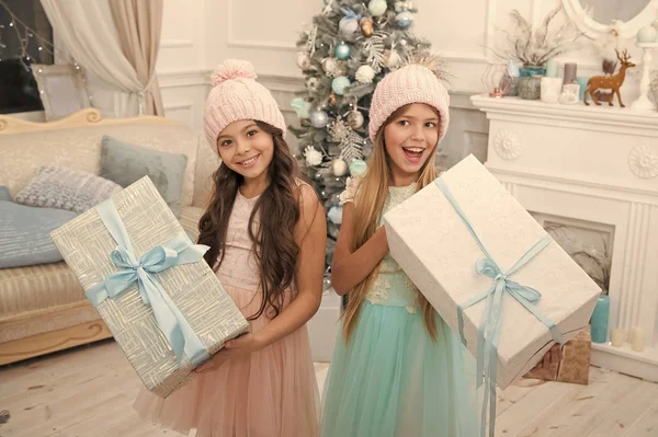 delivery christmas gifts. happy new year. happy little girls sisters celebrate winter holiday. christmas time. Family holiday. little children girl with xmas present. Holiday program