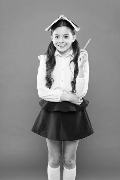 Dealing with school stress. Girl child hold book. School girl studying textbook. Kid school uniform hold book. Excited about knowledge. Life balance and positivity. Everything is under control — Stock Photo, Image