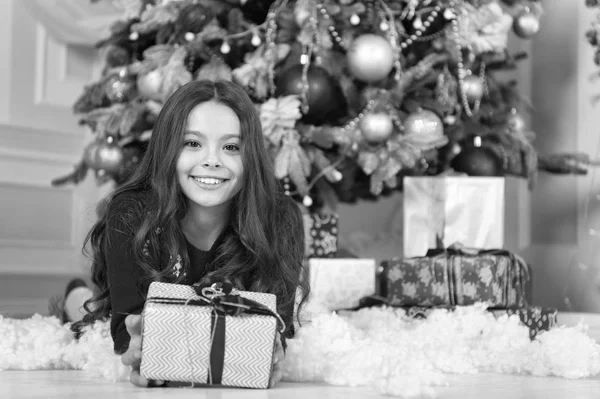 Christmas. Kid enjoy the holiday. The morning before Xmas. New year holiday. Happy new year. little child girl likes xmas present. small happy girl at christmas. Christmas is the time to please