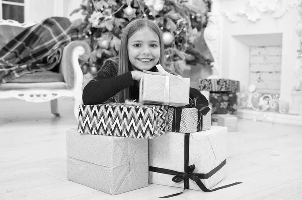 Child enjoy the holiday. Fill our Christmas with joy and cheer. The morning before Xmas. Little girl. Christmas tree and presents. Happy new year. Winter. xmas online shopping. Family holiday