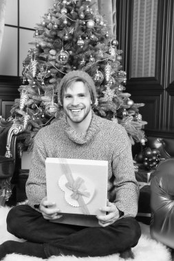 Hediye kutusu oturup Noel ağaç adam gülümseyerek