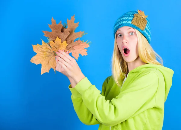 Bright moment. Active leisure and rest autumn season. Woman wear knitted hat hold fallen leaves. Skincare and beauty tips. Skincare routine for autumn. Enjoy autumn season. Autumn skincare tips