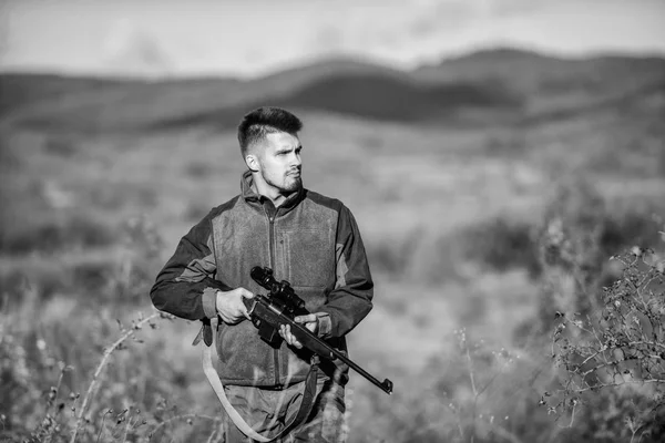 Bearded hunter spend leisure hunting. Hunter hold rifle. Focus and concentration of experienced hunter. Hunting and trapping seasons. Hunting permit. Man brutal gamekeeper nature background — Stock Photo, Image