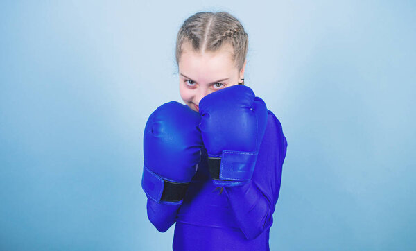 Girl cute boxer on blue background. With great power comes great responsibility. Boxer child in boxing gloves. Rise of women boxers. Female boxer change attitudes within sport. Free and confident