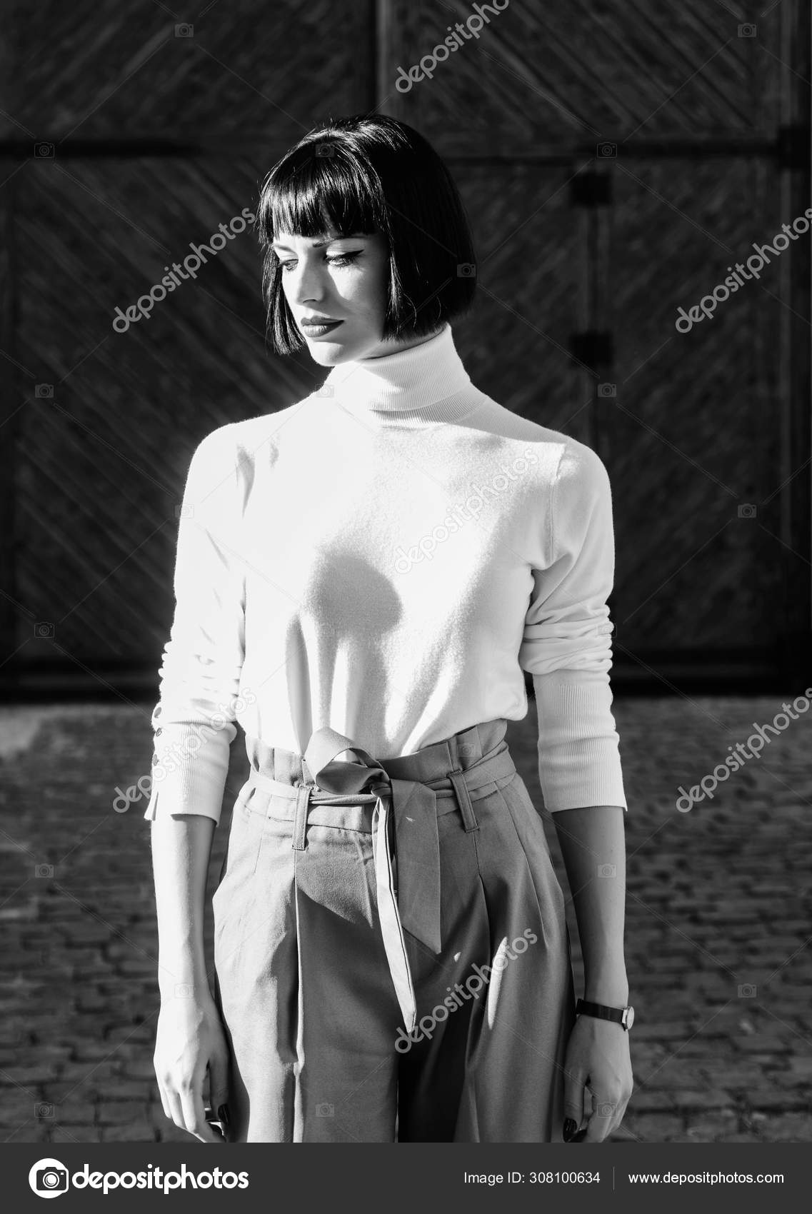 High waisted. Woman attractive brunette fashionable outfit. Femininity and  emphasize feminine figure. Girl makeup face wear loose high waisted pants.  High waisted trousers keep returning to catwalk Stock Photo by ©stetsik  308100634